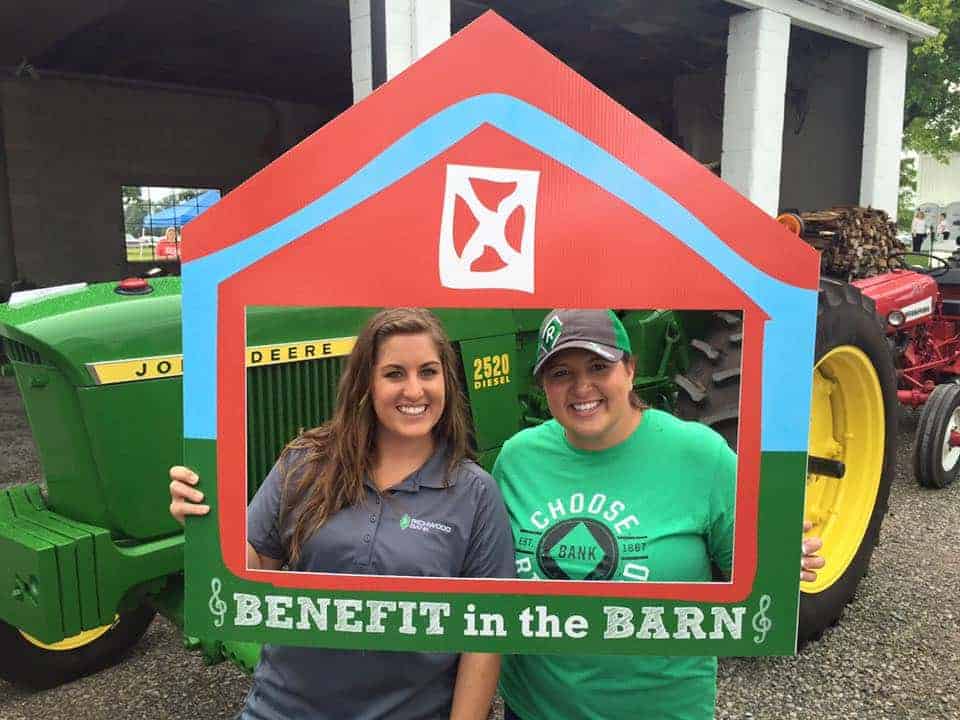 alt="employees at benefit in the barn event"