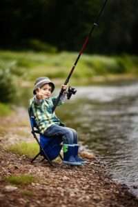 alt="little boy fishing"