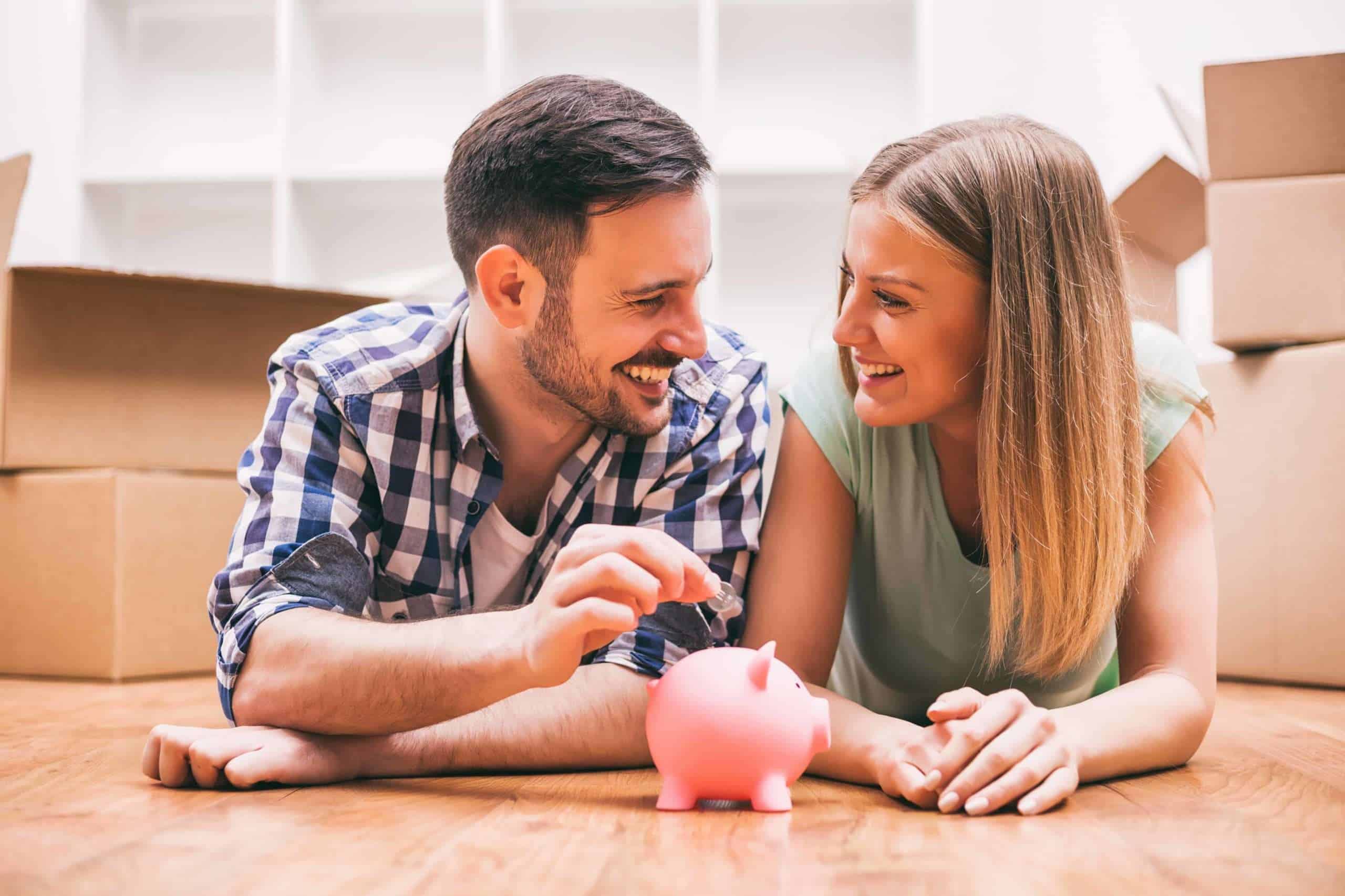 couple-inserting-money-into-piggy-bank