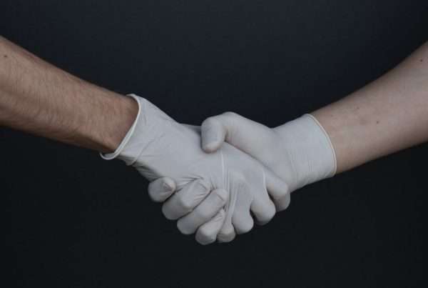 people-shaking-hands-with-gloves